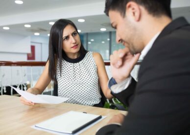 upset-business-lady-dressing-down-employee-mistakes-min